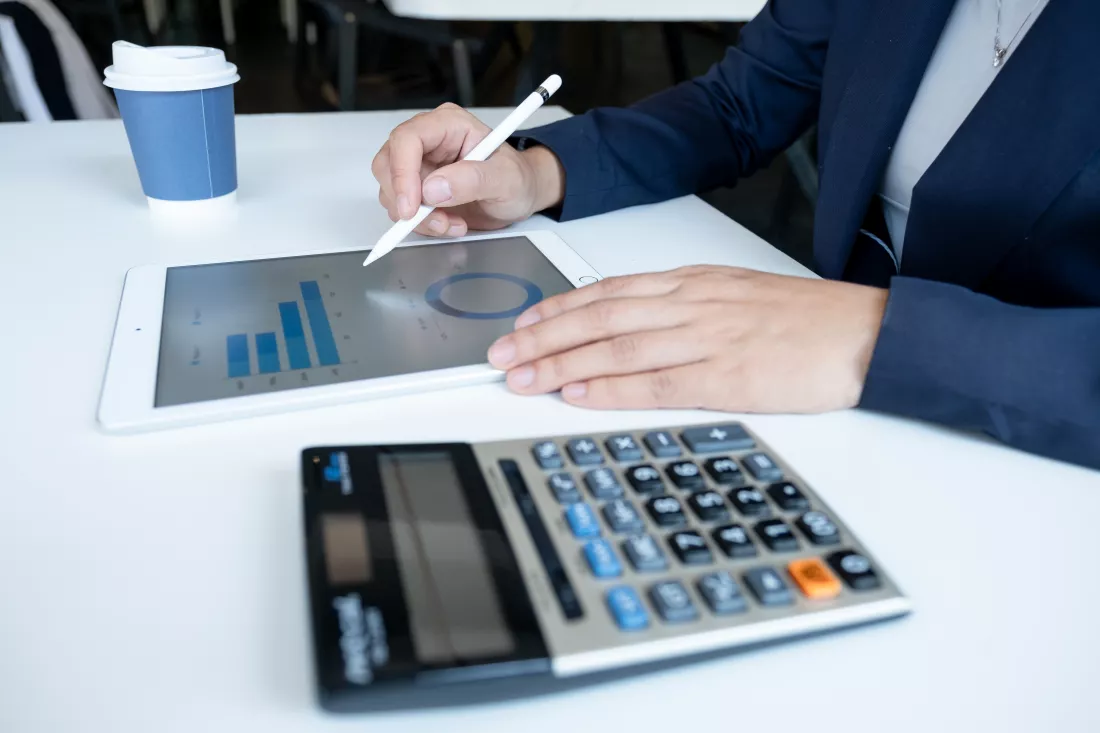 midsection-woman-using-digital-tablet-table