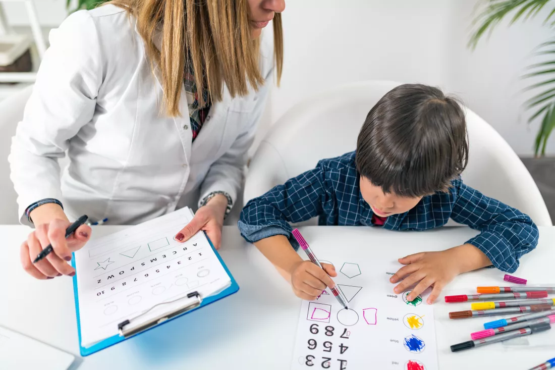 teacher-student-drawing-table-classroom